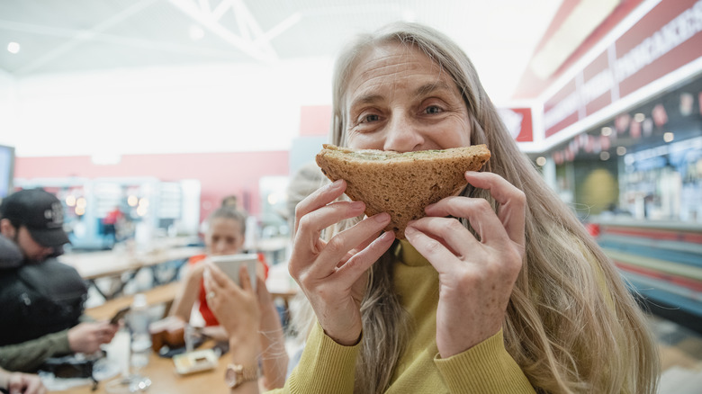 Traveler holding sandwich at airport