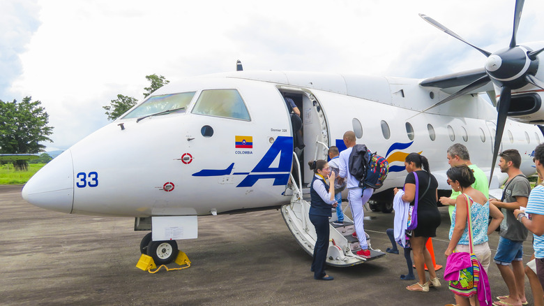 Small airplane boarding passengers