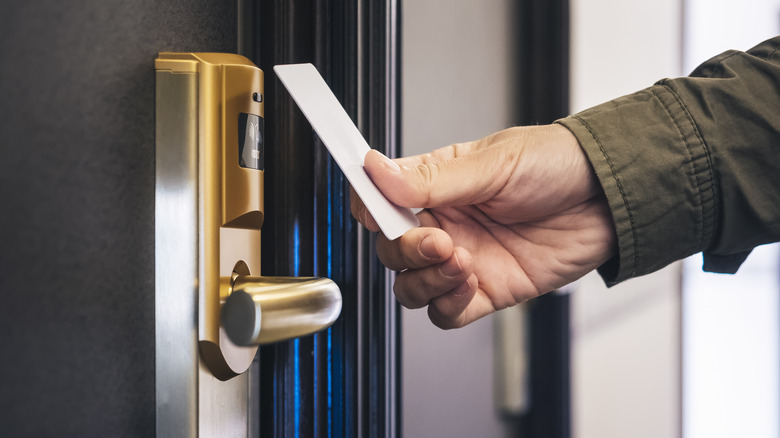 Hotel room door and hand holding key card