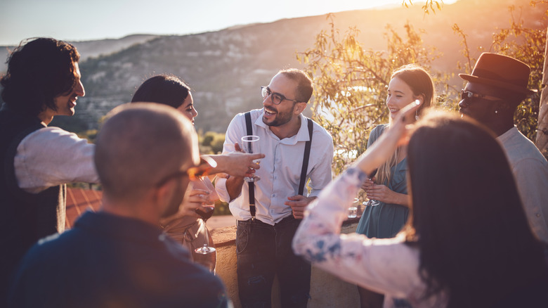 Stylish friends drinking wine