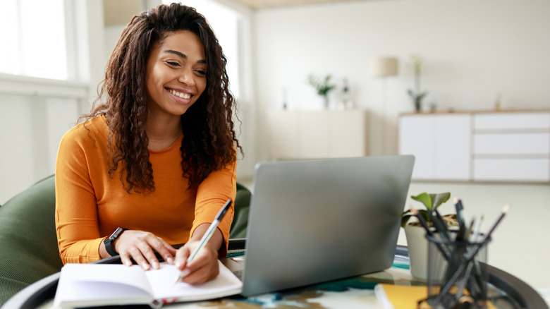 woman smiling working at computer