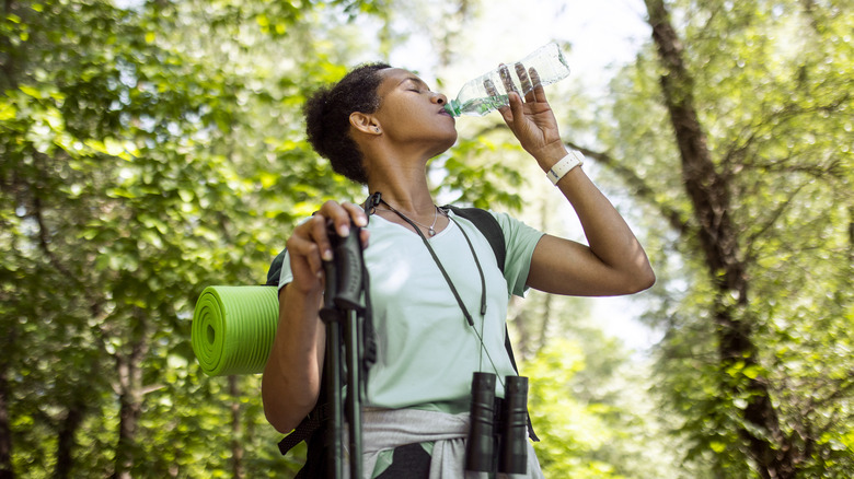 Woman hiking drinking water 