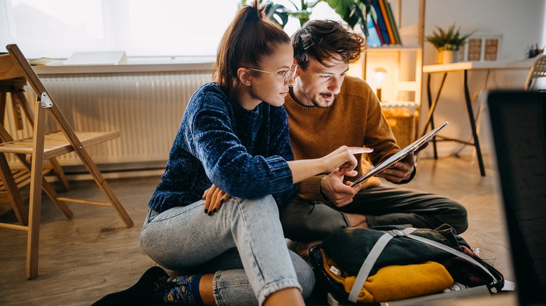 couple planning trip on tablet