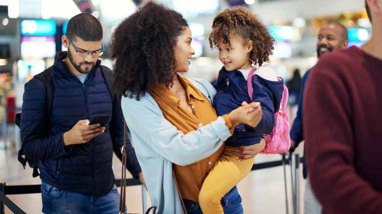 Mother and daughter on line at airport