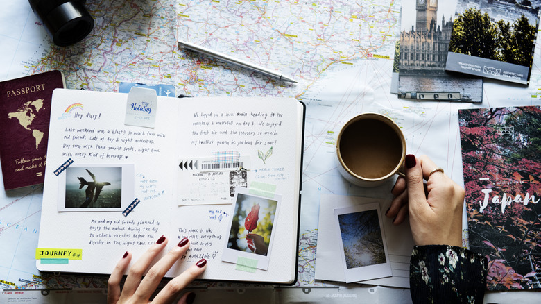 A woman looking at her travel journal