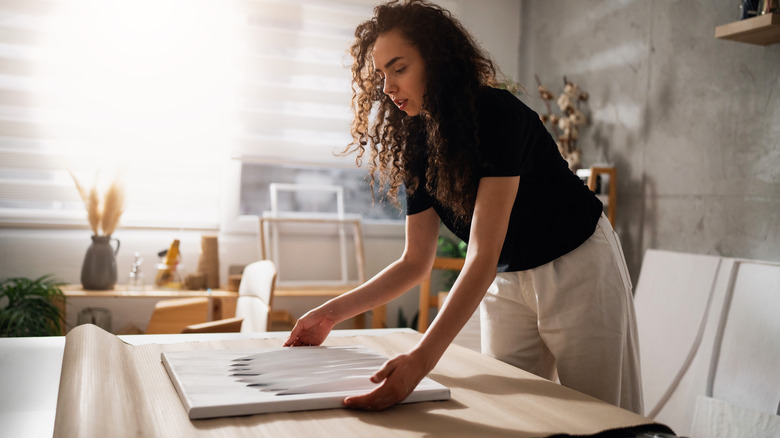 Woman wrapping a canvas