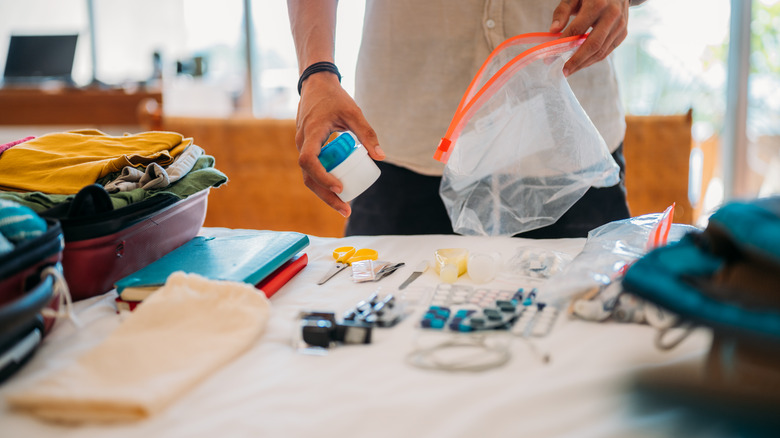 Man packing medicine and toiletries