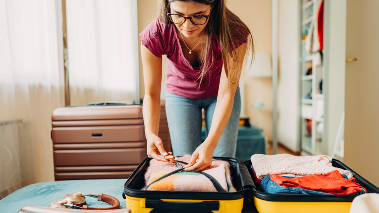 woman packing suitcase