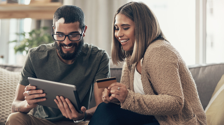 A happy couple booking flights online