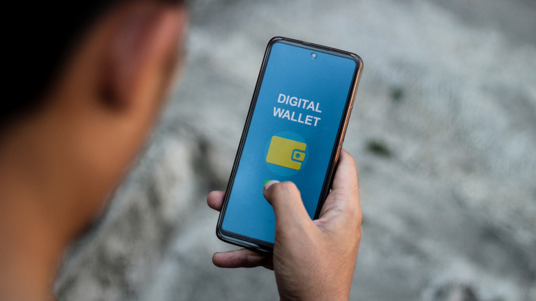 A man checking his digital wallet on his phone