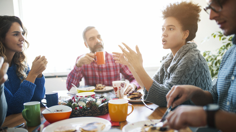 A group of people talking over a meal