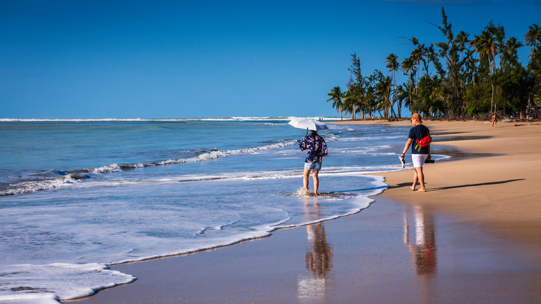 Tourists walking on Luquillo Beach in Puerto Rico