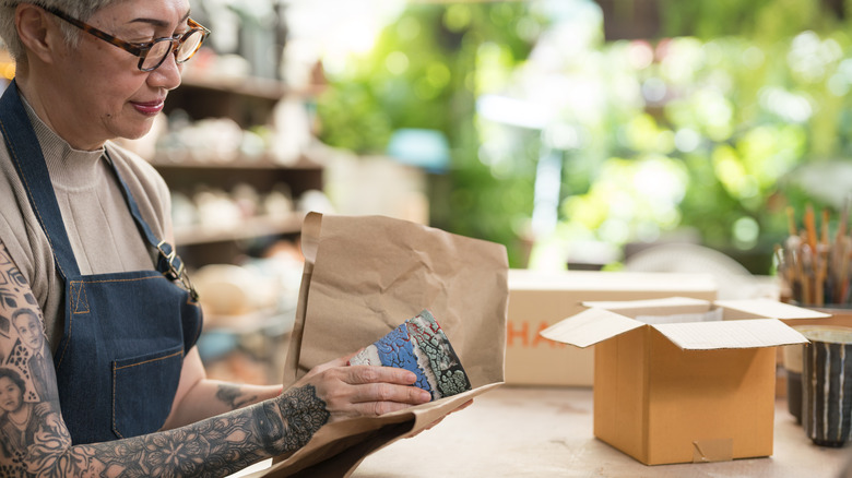 artist wrapping pottery