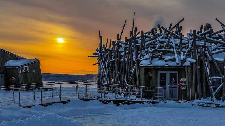 log buildings and snow at sunset