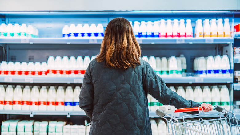 Woman looking at milk aisle