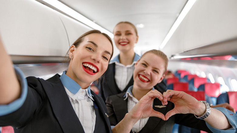 Young flight attendants posing for camera