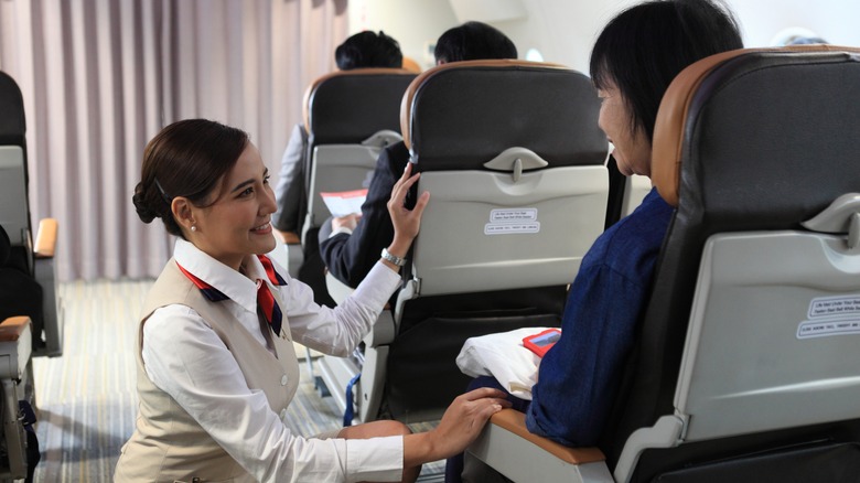 Flight attendant smiling at a passenger