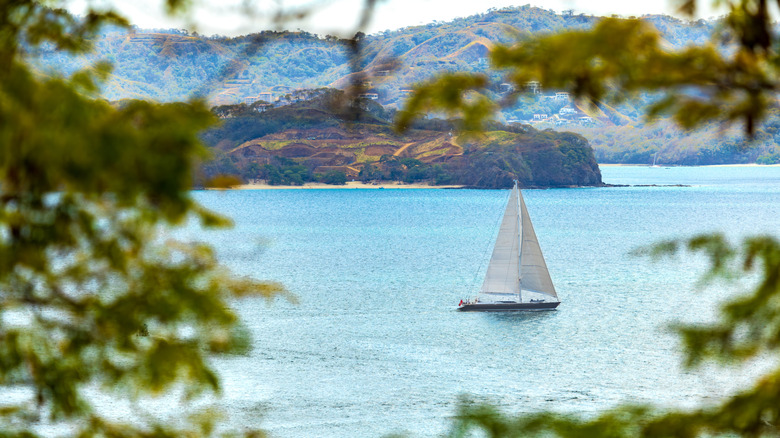 Sailboat cuts through bay off coast of Papagayo, Costa Rica