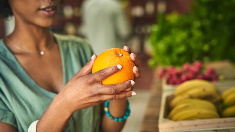 woman holding orange