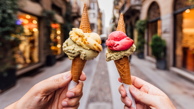 two hands holding gelato cones