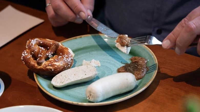 Person eating weisswurst in Germany