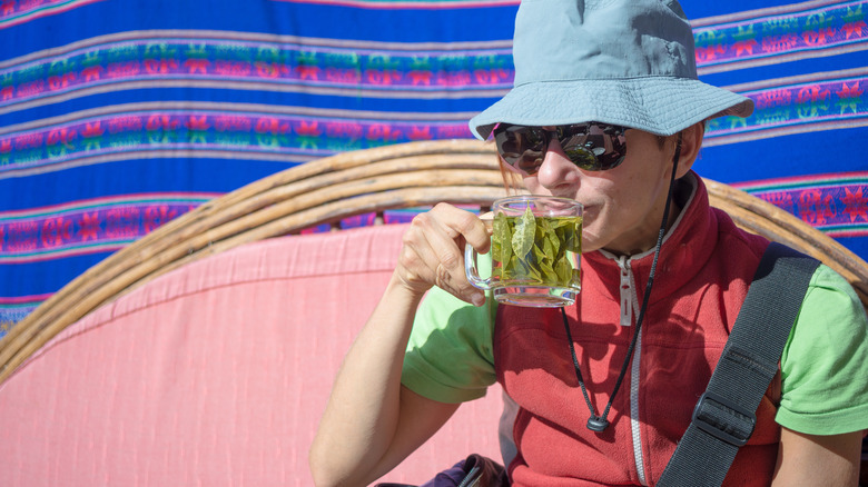 Traveler drinking a mug of coca leaf tea