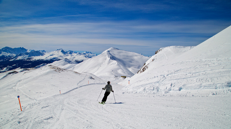 Person skiing with mountains in background