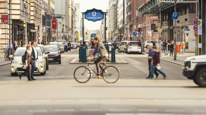 People crossing and biking on a busy street in Germany