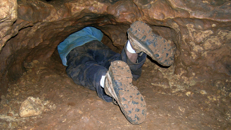 feet sticking out of cavern