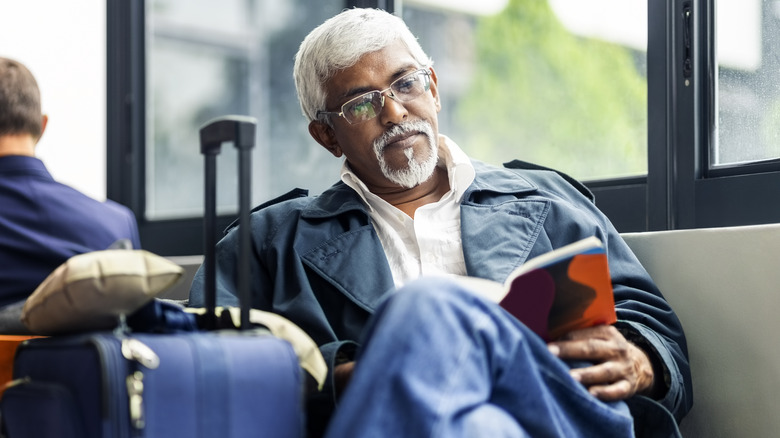 man reading at airport