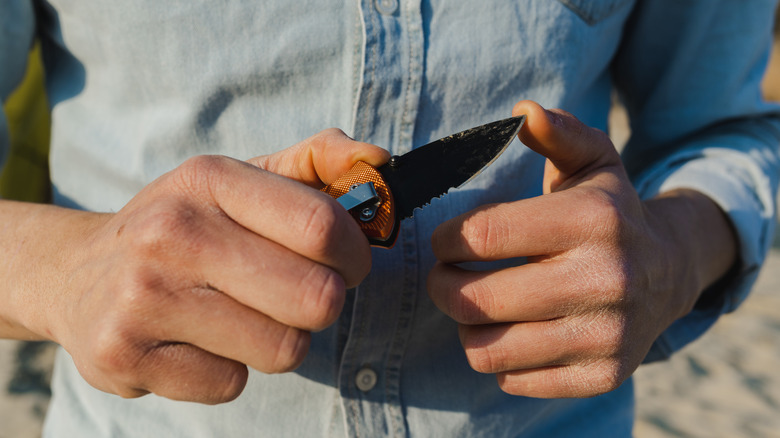 man holding pocket knife
