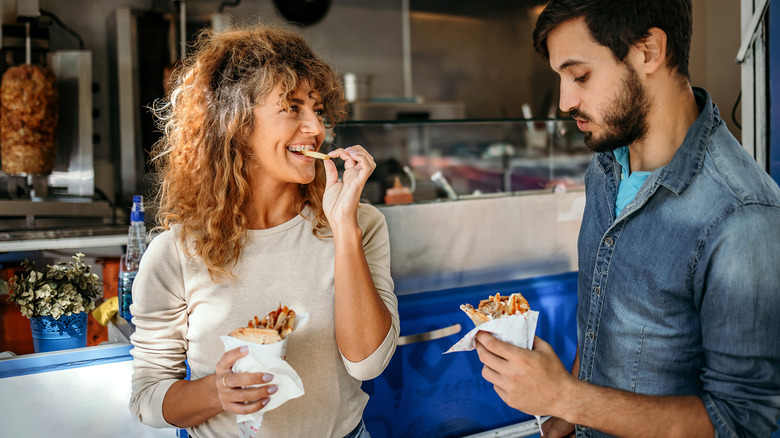 Travelers eating a kebab