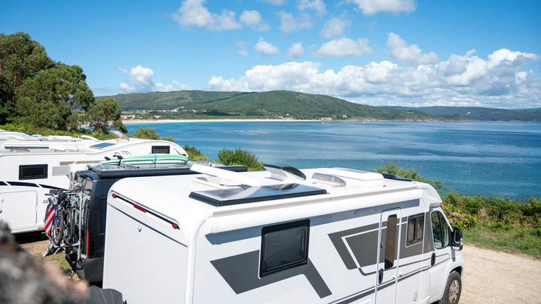 Campervans parked near a beach coastline