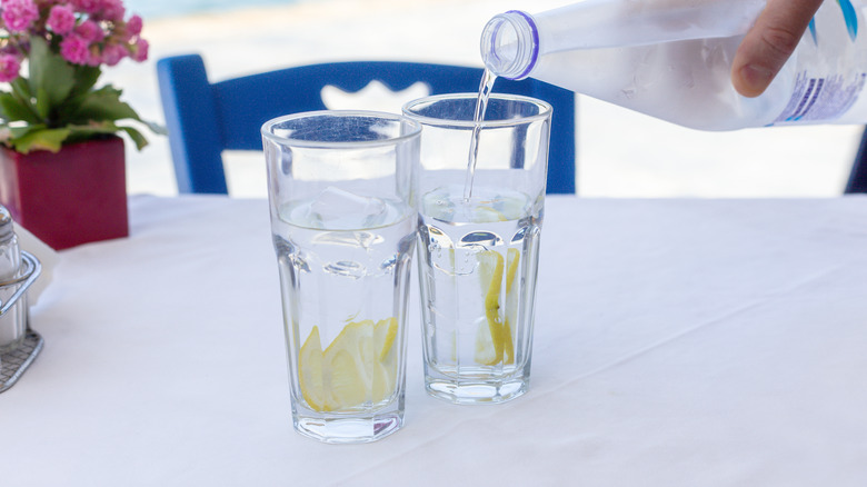 water poured into glasses on table