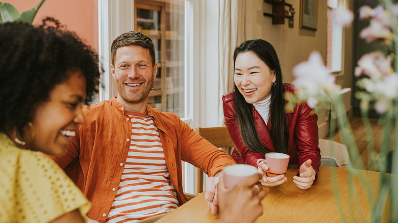 Friends laughing in a coffee shop