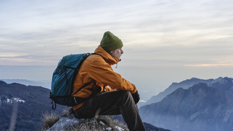 Mountain climber with orange windbreaker