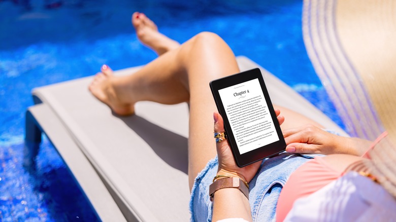 Woman with e-reader at pool