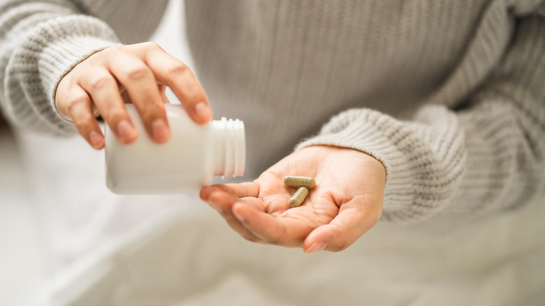 Woman pouring pills 