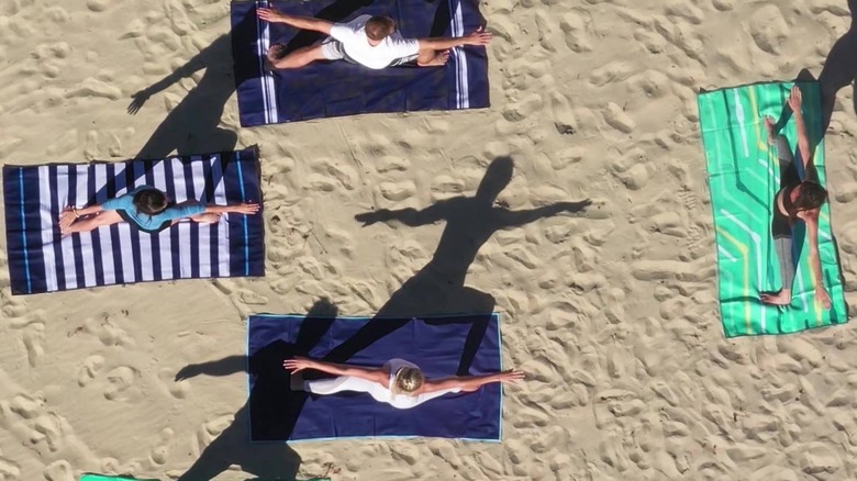 Beach yoga on sand-free mats