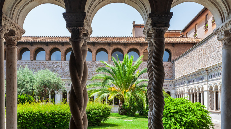 View of arches and a courtyard in a cloister in Italy