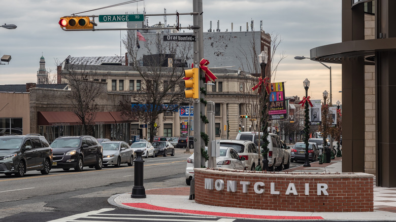 Montclair New Jersey town sign with street view of buildings and cars