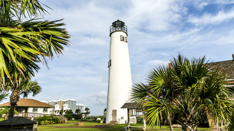 Lighthouse in Eastpoint, Florida with houses in background