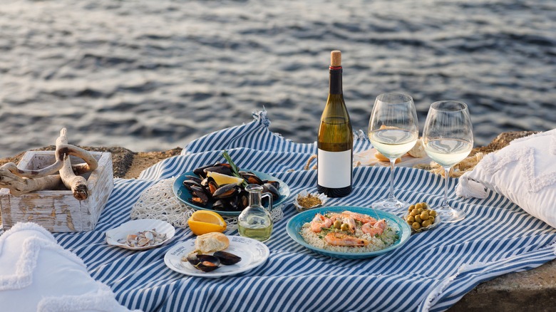 Seafood picnic spread with ocean in background