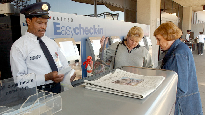 Skycap attendant with passengers