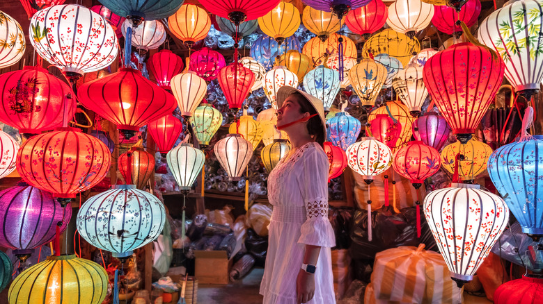 Solo traveler surrounded by lanterns
