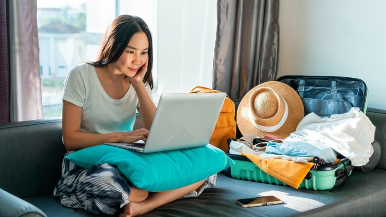 Traveling woman using laptop