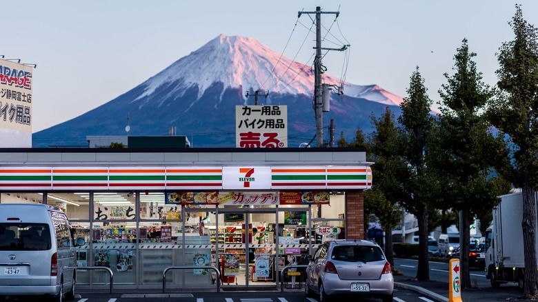 A 7-Eleven store stands at the foot of Mount Fuji