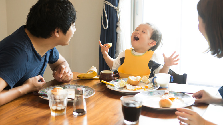 Japanese family eating at dining room table