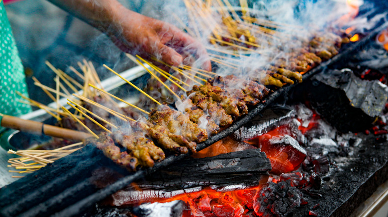 Skewers cooking over open grill