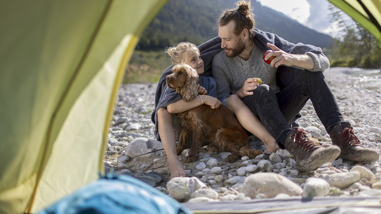 Family camping with their dog